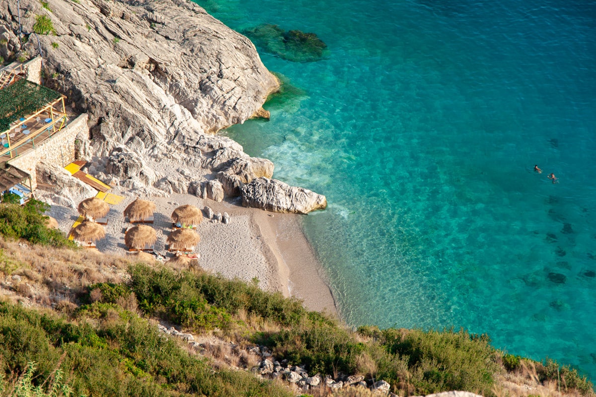 A beach club along the Albanian Riviera wedged into the cliffs