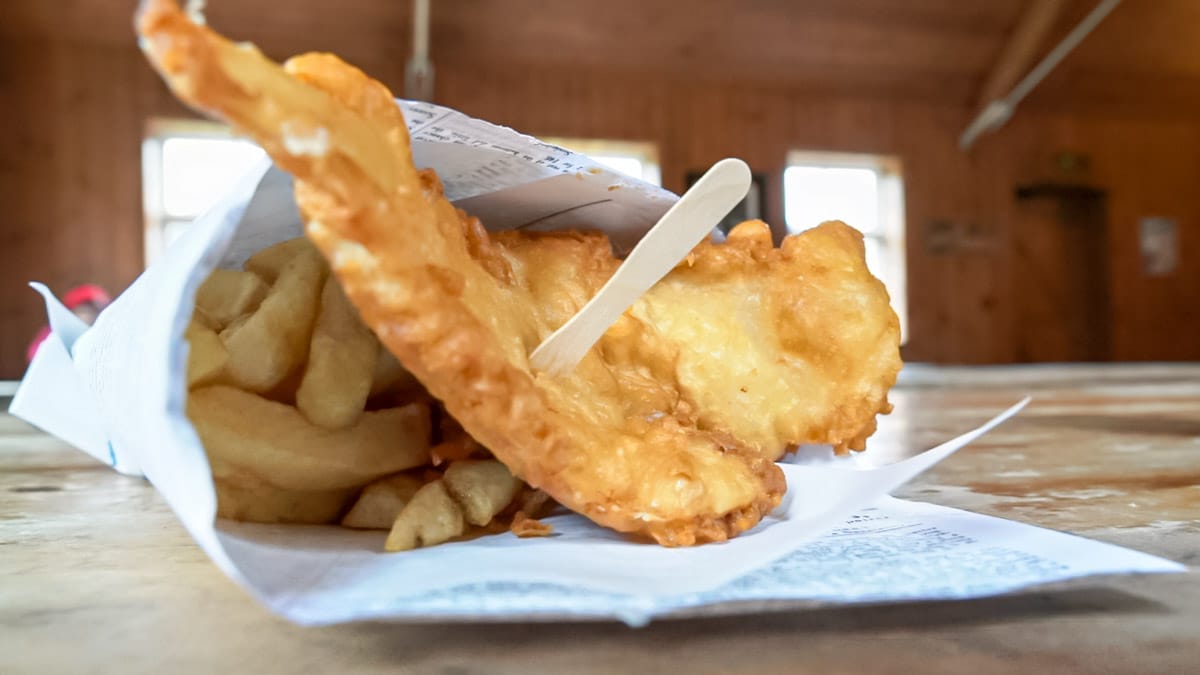 Fish and chips wrapped in paper and is one of the UK's best experiences