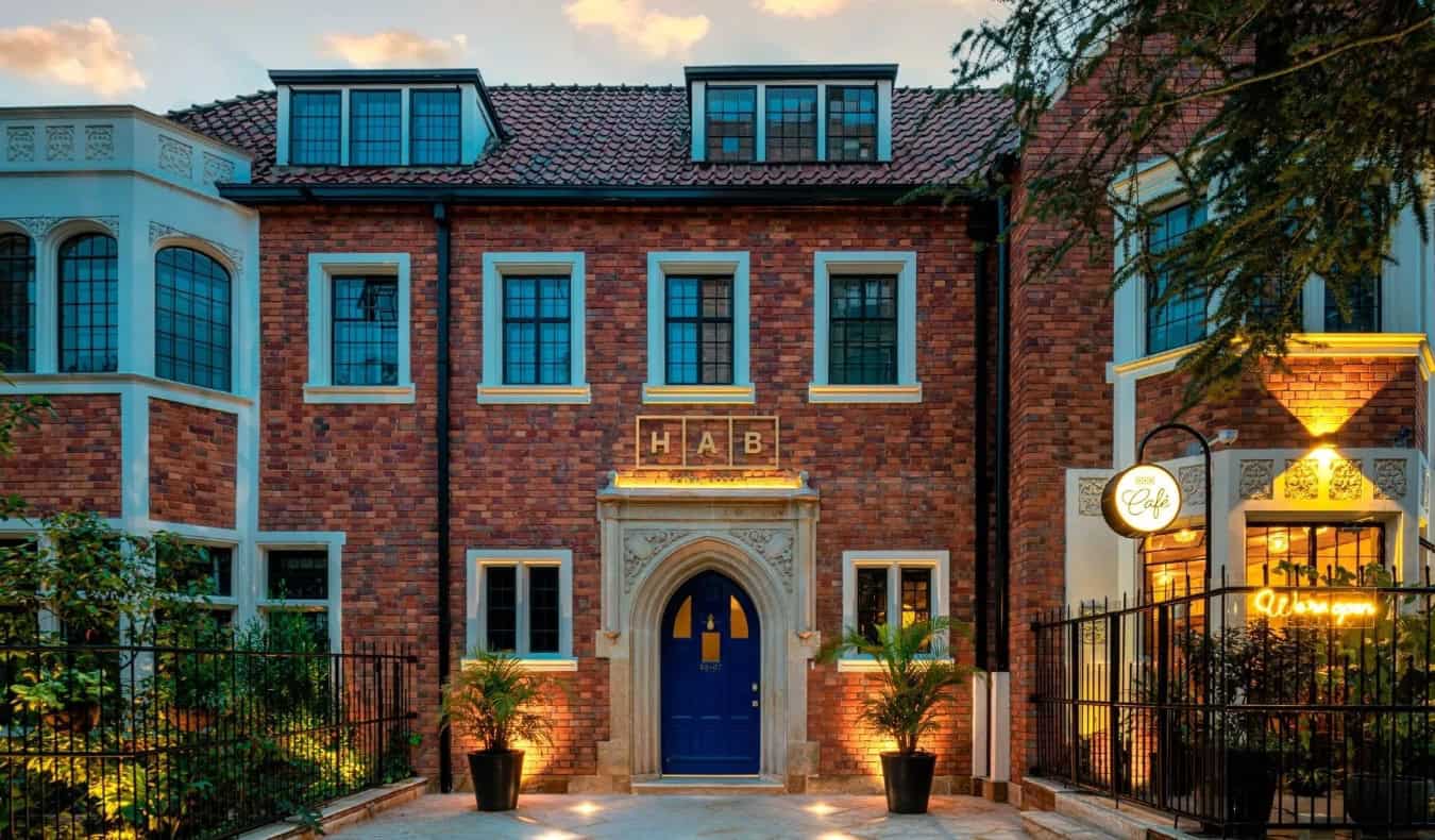 Historic brick mansion, with an arched stone entryway and windows, home of HAB Hotel Bogotá in Colombia