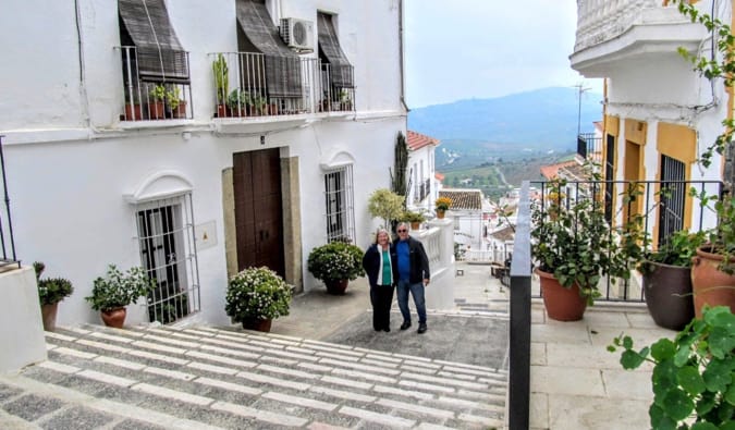 A retired couple traveling in Europe together in a small town