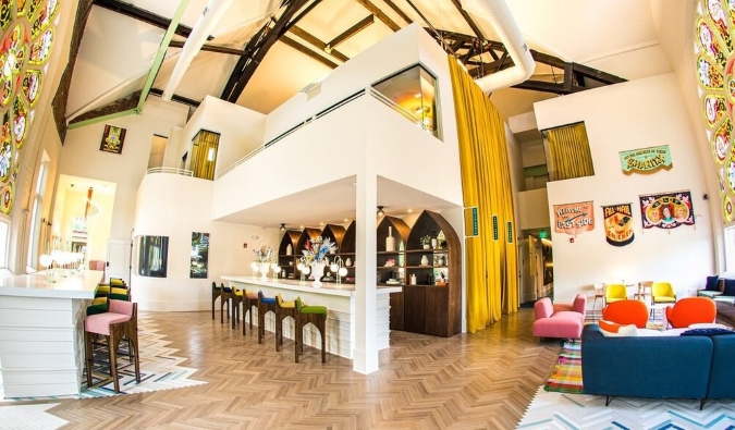 360 view of the expansive lobby with a huge stained glass window at The Russell, a boutique hotel in a former church in Nashville, TN