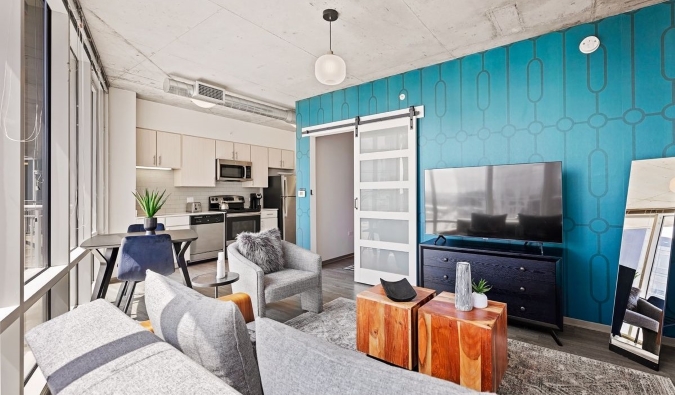 The light-filled living room and kitchen of a suite at Placemakr SoBro, an apart-hotel in Nashville, TN