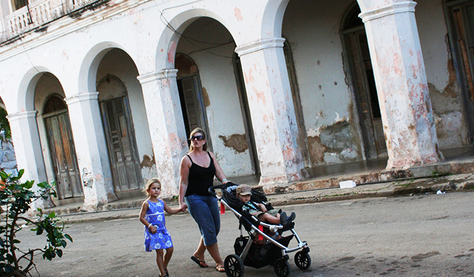 a traveling family walking down an empty street